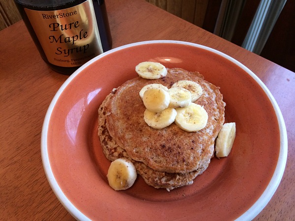 Pancakes with banana, cinnamon, and maple syrup. 