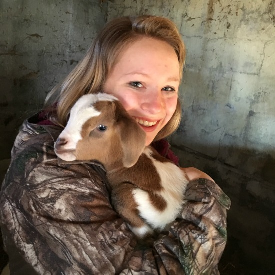 Hannah holding a baby goat