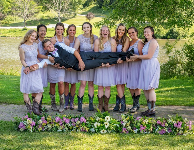 Bridesmaids holding groom