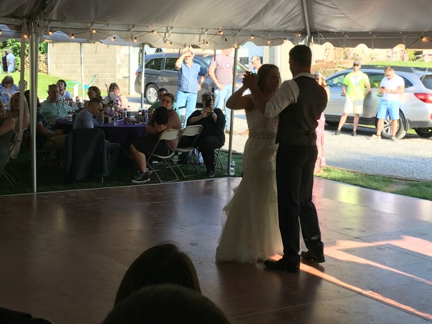 Bride and groom dancing at rustic country outdoor wedding