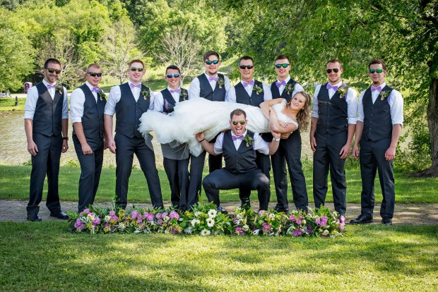 Groomsmen holding bride
