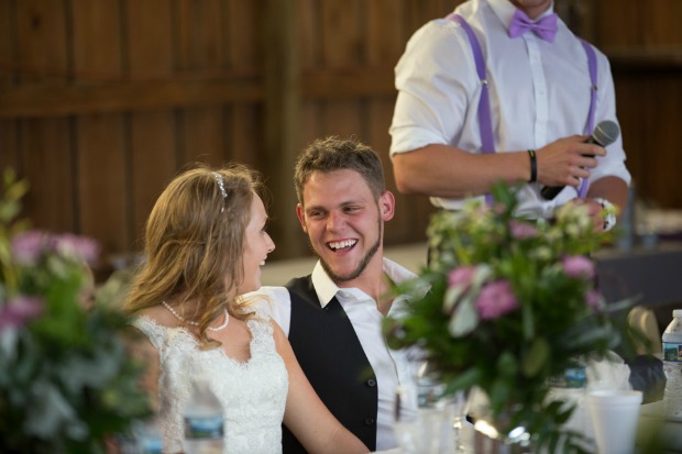 Bride and groom laughing at reception