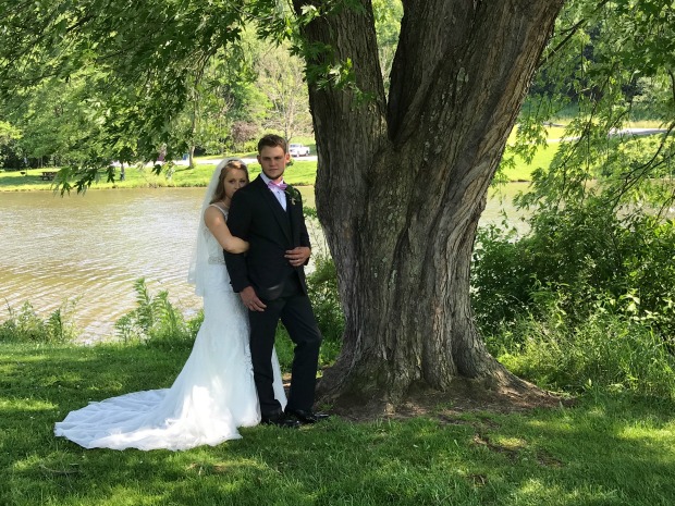 Wedding pictures in park by water and trees