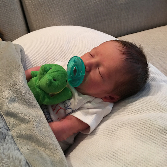 Baby with frog Wubbanub pacifier 