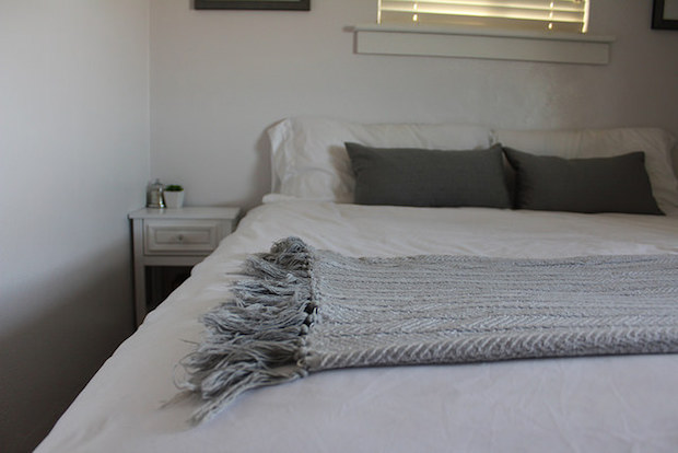 Gray and white blanket with tassels