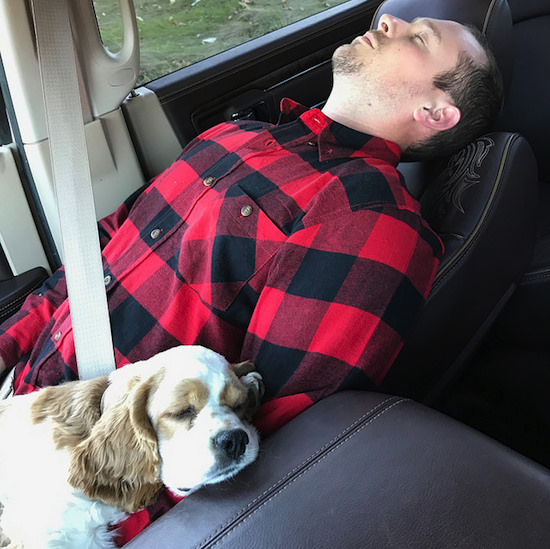 Man and puppy sleeping together