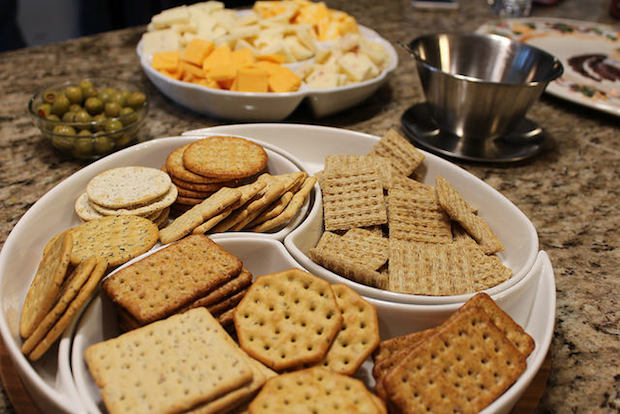 Cheese and cracker plate with green olives