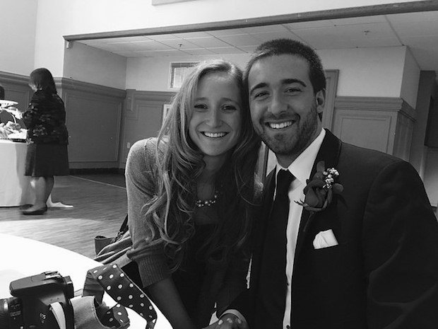 Couple at wedding reception table in black and white