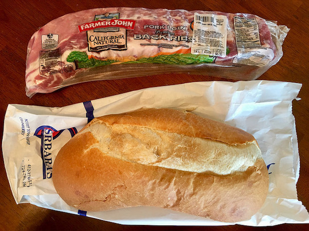 Fresh loaf of Italian bread and baby back pork ribs