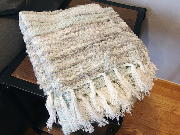 Blue and gray blanket with tassels