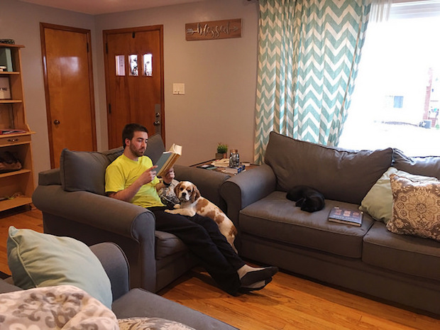 Guy reading with cocker spaniel