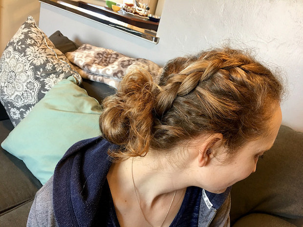 Blonde hair braided into dutch braid or french braid