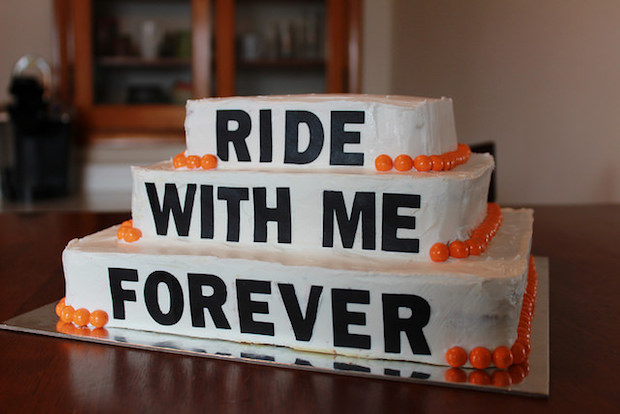 Harley Davidson black and orange wedding cake that says ride with me forever
