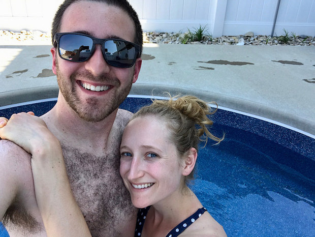 Young couple smiling selfie in pool