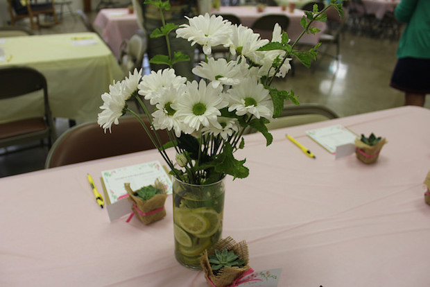 Daisy centerpieces with lemons and mint sprigs