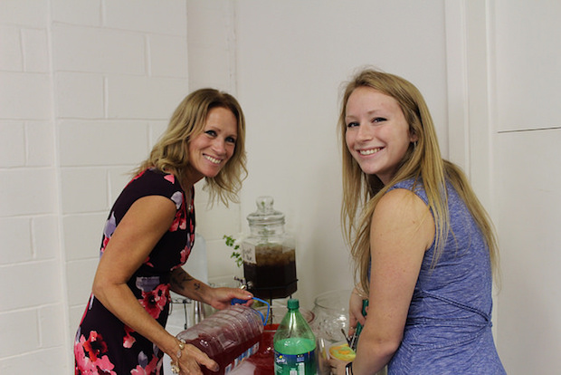 Mother and daughter pouring punch at baby shower