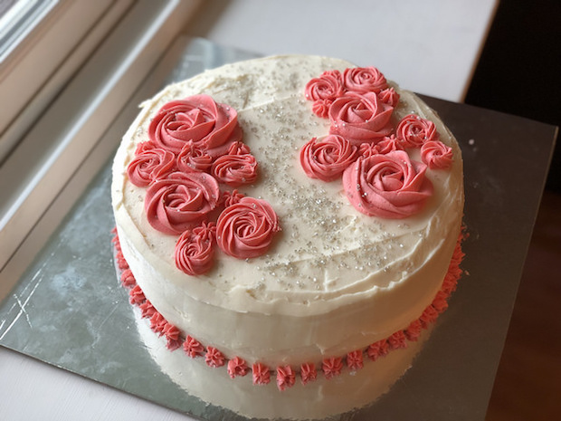 Strawberry cake with vanilla buttercream and rosettes with silver sprinkles