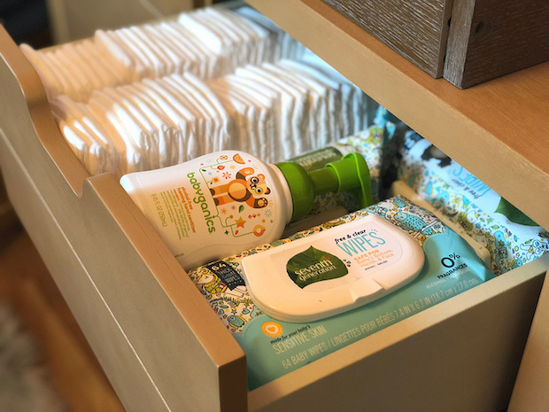 Drawer filled with Pampers diapers, Seventh Generation free and clear wipes and Babyganics foaming hand sanitizer