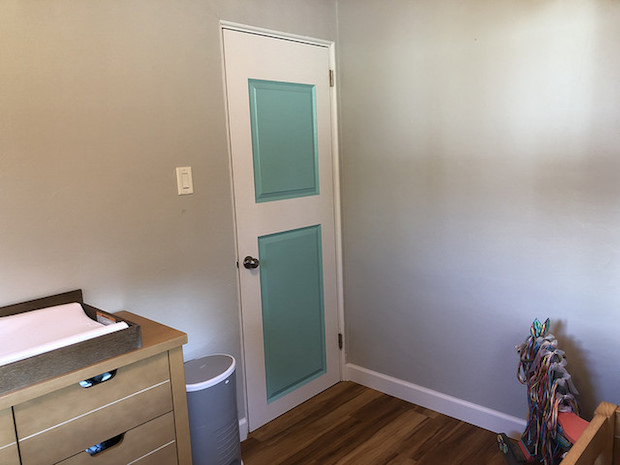Blue and white painted door in baby nursery