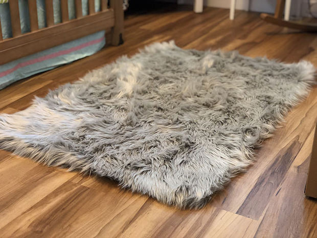 Fuzzy gray Nicole Miller rug on wood floor