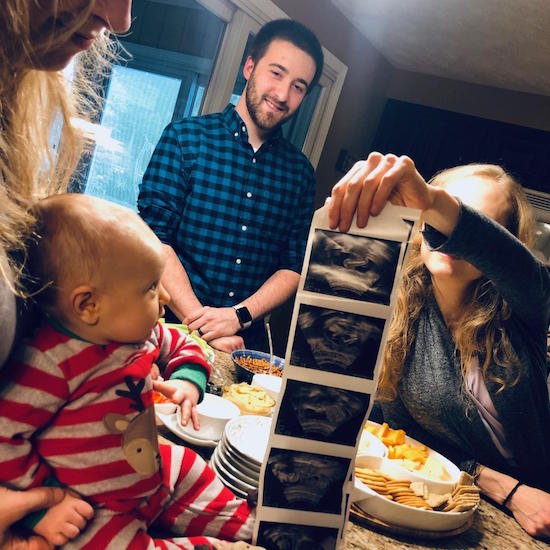 Holding up ultrasound to baby