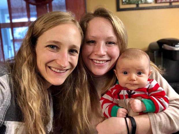 Sisters with baby daughter