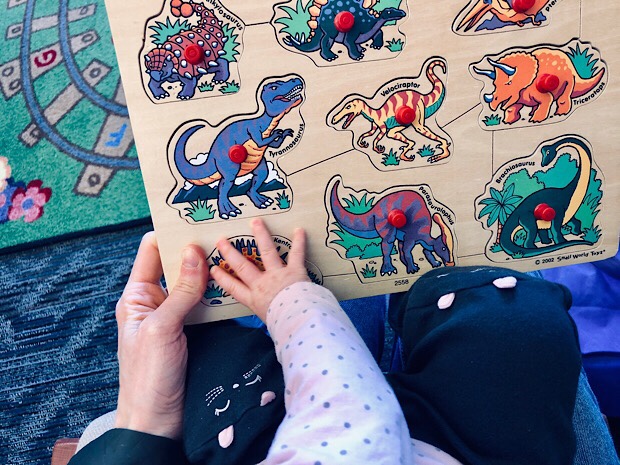 Baby and mom doing dinosaur puzzle