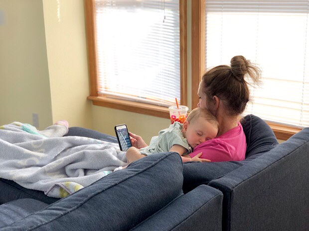 Baby girl sleeping in grandmother's arms