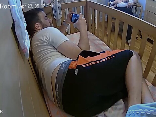 Guy inside of baby's crib