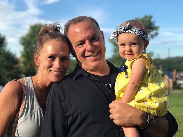 Grandparents holdin baby girl