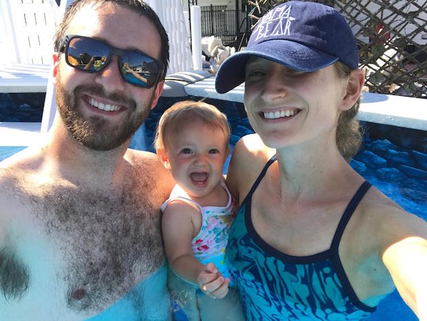 Family swimming with baby girl
