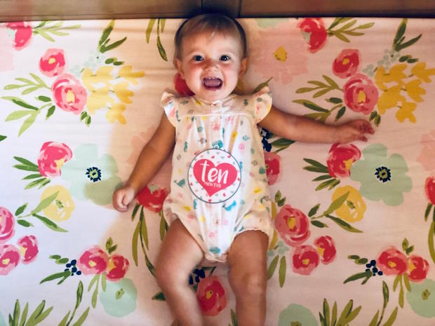 Ten month old baby girl in crib