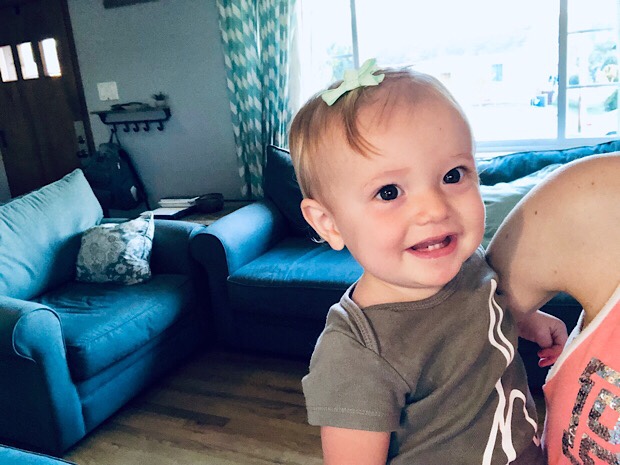 Baby girl smiling with bow in her hair