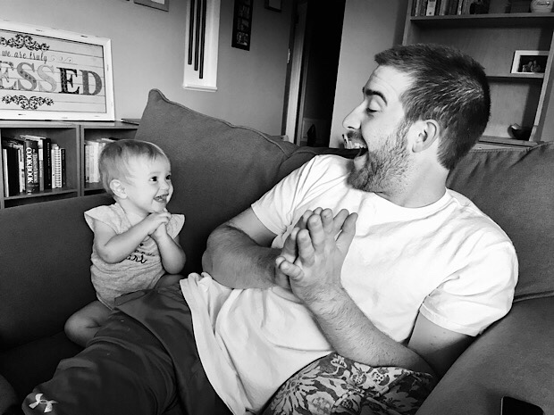 Baby girl and dad smiling and clapping