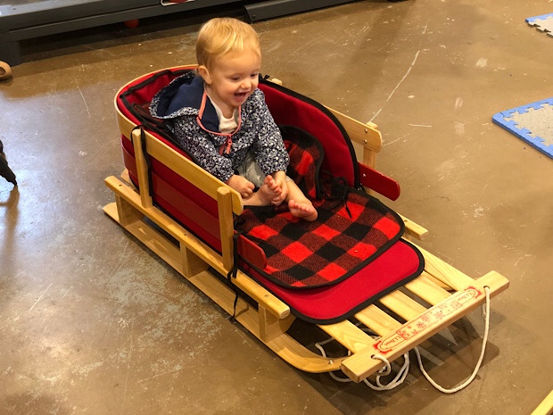 Baby girl sitting in LL Bean sled
