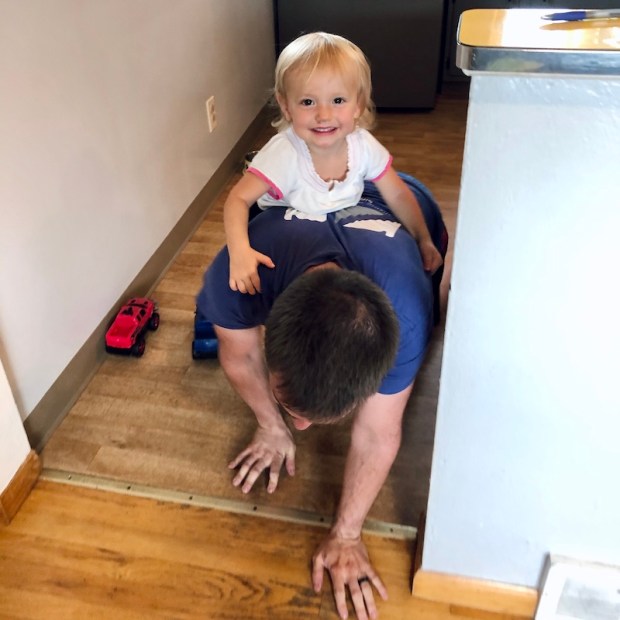 Toddler riding on dad's back