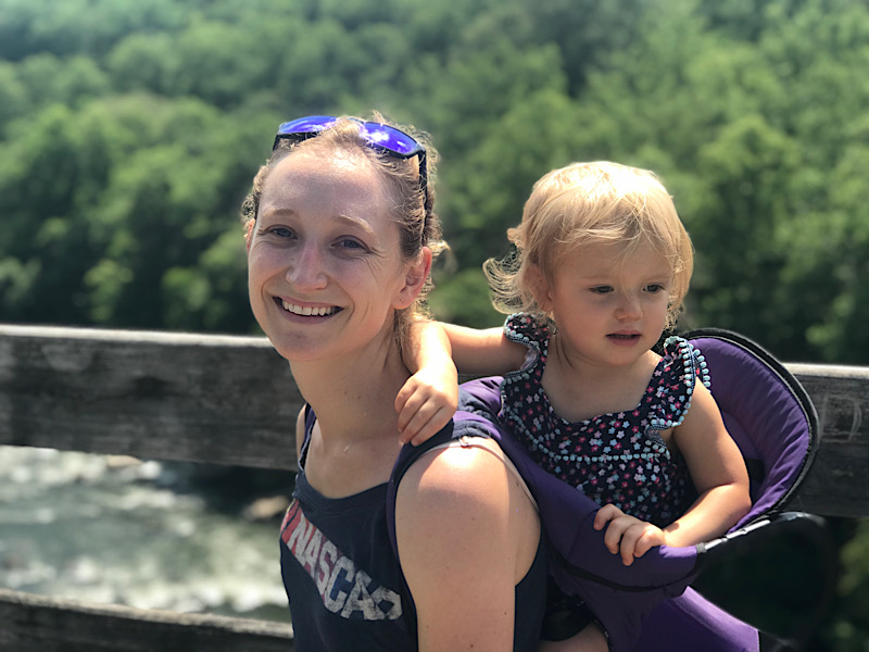Mom with toddler in hiking backpack
