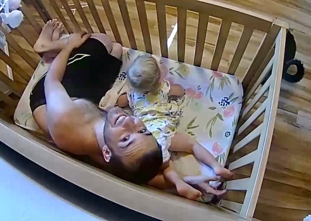 Dad in crib with baby