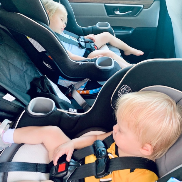 Toddlers sleeping in carseats