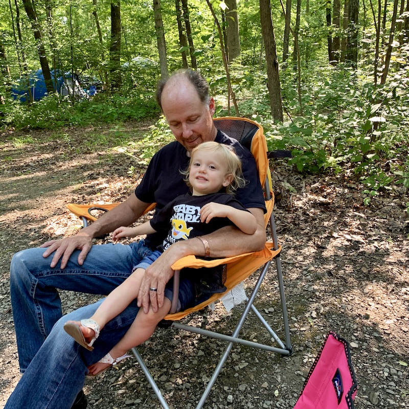 Toddler with grandpa while camping