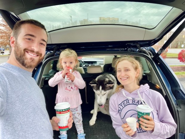 Family drinking Starbucks coffee with dog
