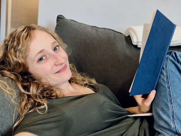 Girl sitting on couch reading