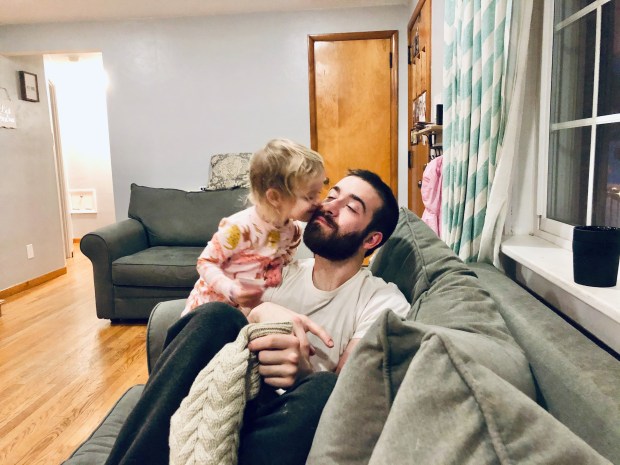 Toddler kissing dad on the cheek