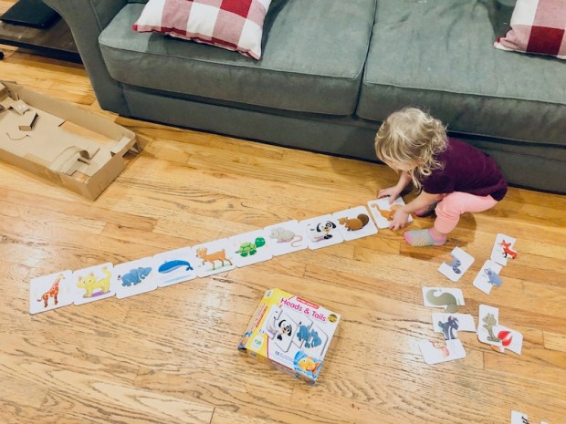 Toddler playing with self-correcting matching puzzle game