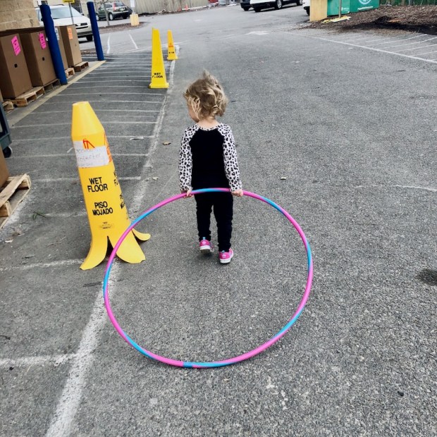 Toddler carrying hula hoop