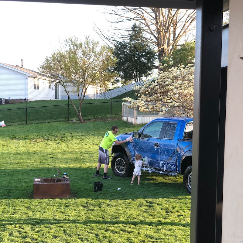 Father and daughter washing truck together