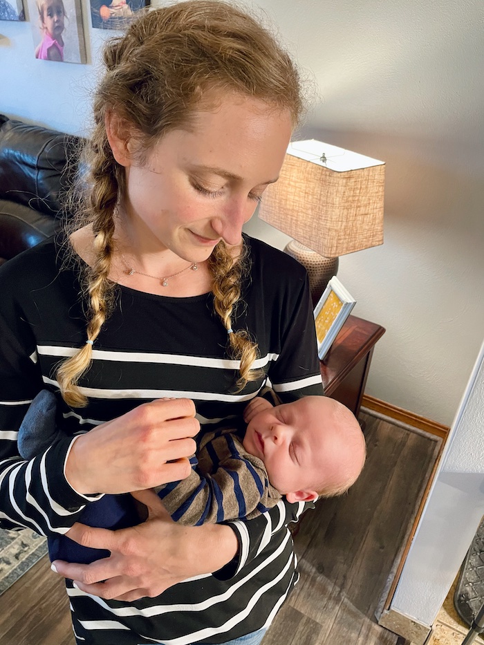 Girl holding newborn baby boy