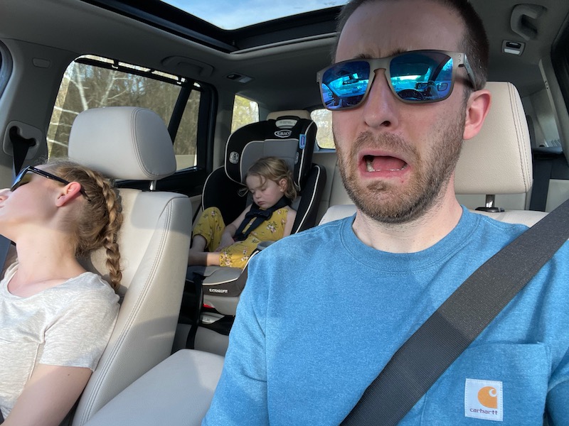 Mom and daughter sleeping in car while dad drives