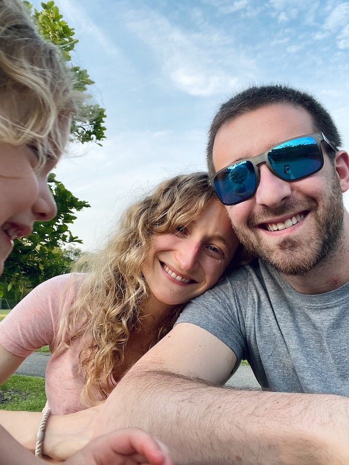 Mom and dad with daughter photobombing a selfie