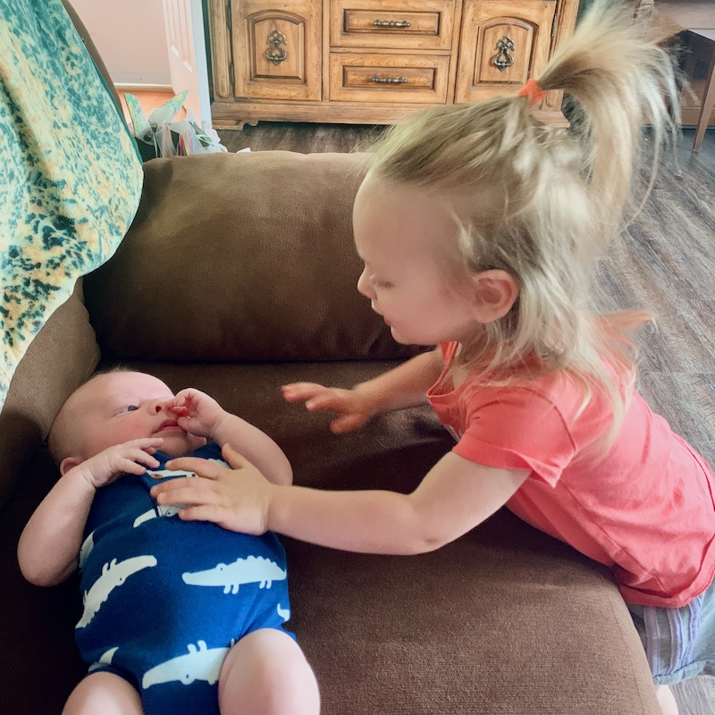 Toddler meeting baby boy